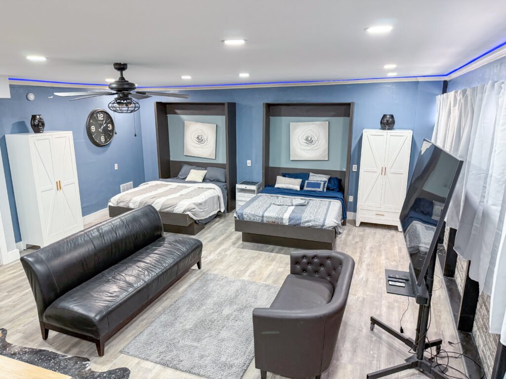 Main room inside Unit 1 at The Flight Deck Residences, showing lounge seating and sleeping area.