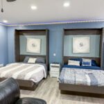 Sleeping area inside Unit 1 at The Flight Deck Residences with two beds and blue accent lighting.