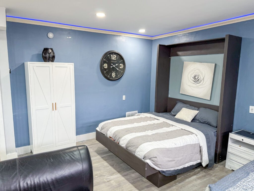 Bedroom with platform bed and armoire wardrobe inside Unit 1 at The Flight Deck Residences.