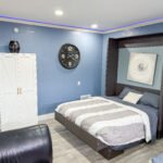 Bedroom with platform bed and armoire wardrobe inside Unit 1 at The Flight Deck Residences.