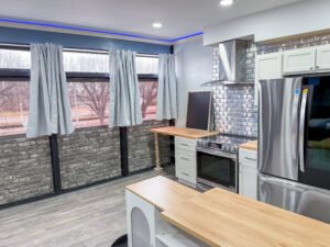 Kitchen with range and butcher block counter inside Unit 1 at The Flight Deck Residences.