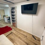 Living area with wall-mounted television inside Unit 2 at The Flight Deck Residences.