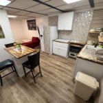 Open living space showing dining, kitchen, and lounge areas inside Unit 2 at The Flight Deck Residences.