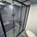 Bathroom with glass shower enclosure inside Unit 3 at The Flight Deck Residences.