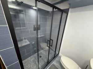 Bathroom with glass shower enclosure inside Unit 3 at The Flight Deck Residences.