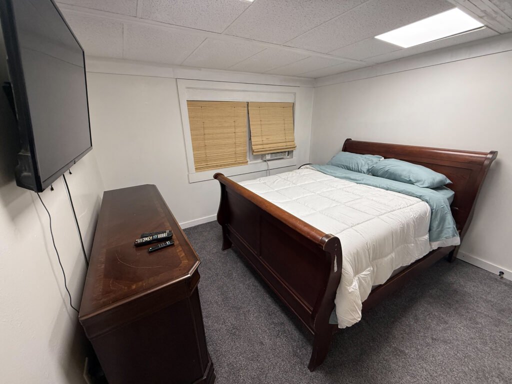 Bedroom with sleigh bed inside Unit 3 at The Flight Deck Residences.