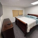 Bedroom with sleigh bed inside Unit 3 at The Flight Deck Residences.