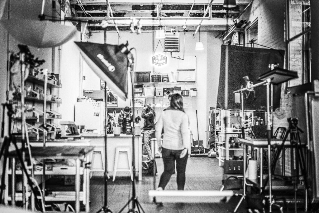 Photographer working with a subject on set